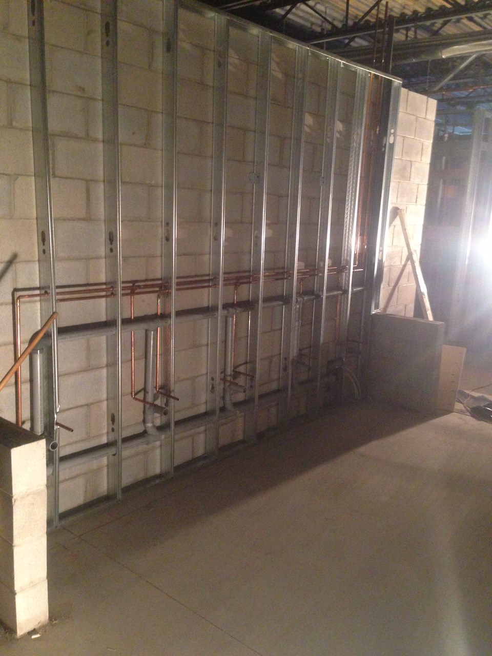 Copper pipes behind wall